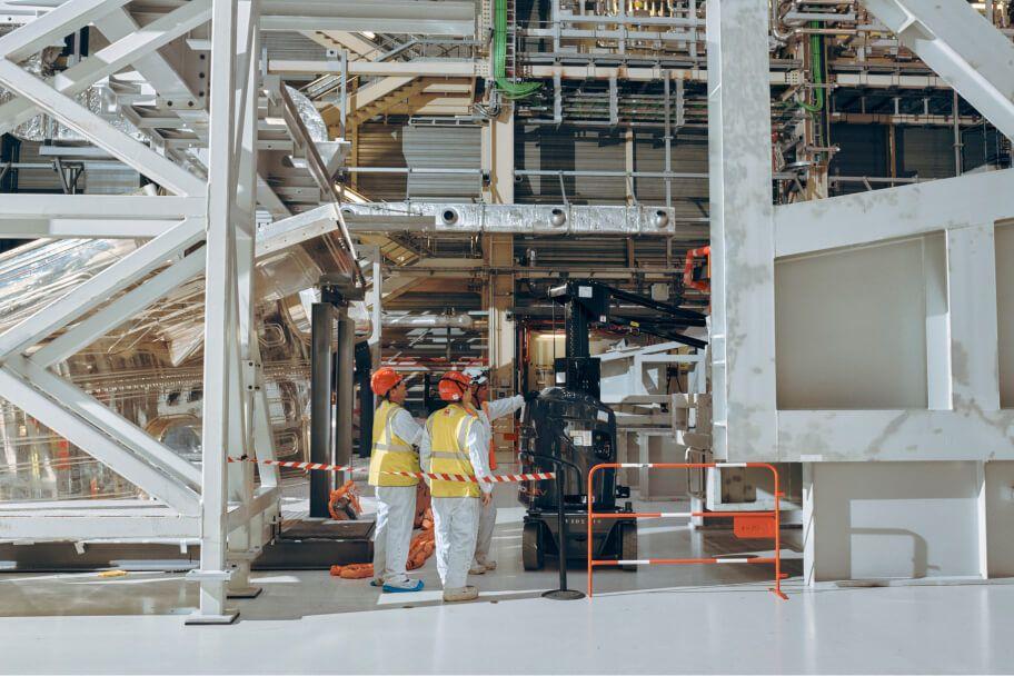 workers in industrial setting wearing safety gear